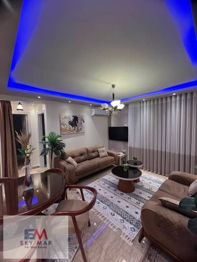 Furnished apartment for rent in Madinaty (B7), featuring high-end (super-lux) finishes and brand-new furniture. It boasts a prime location directly ov