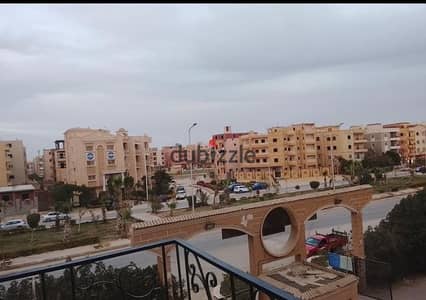 Apartment for sale in Zaher City Compound, 80 meters on the Spanish district road, with semi-finishing and a price offer for quick sale at the best location in October Gardens
