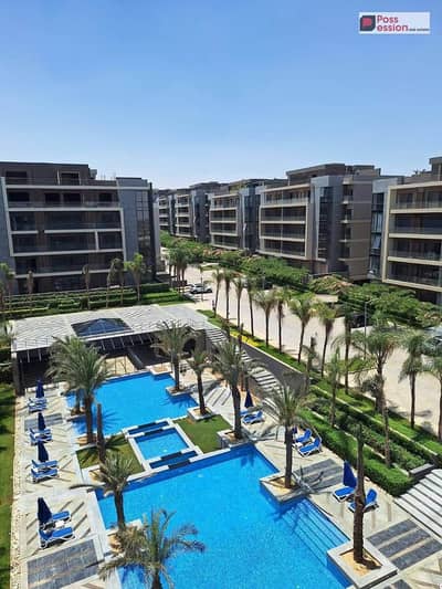 Apartment with Garden  for sale, in La Vista Patio Oro compound, featuring an open view overlooking the pools, prime location New Cairo