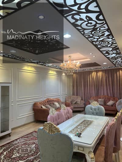 140-meter apartment in Madinaty   in Madinaty – b10 Ultra Super Lux finishing – modern fully furnished in the finest locations of Madinaty, two houses, ready for immediate residence, with luxurious finishes and modern furniture at the highest level.   Specifications: 	•	Three complete bedrooms 	•	Two bathrooms 	•	Spacious reception 	•	Kitchen equipped with the latest devices
