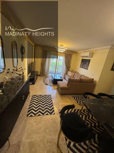 Furnished apartment for rent in Madinaty B10, a unique opportunity to live in one of the best areas of Madinaty in phase 10 B10, group 103, in a very distinguished location just steps from the services area and All Seasons Park mall. The apartment has an area of 116 square meters, located on the first upper floor, and features a double open view.