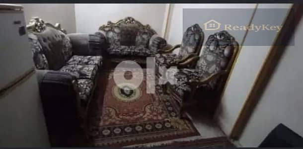 Furnished apartment for rent with two rooms and a hall, a bedroom with 2 beds, the hall has a sofa set, and the kitchen includes a stove, washing machine, and refrigerator. There is a television with a receiver in the apartment.