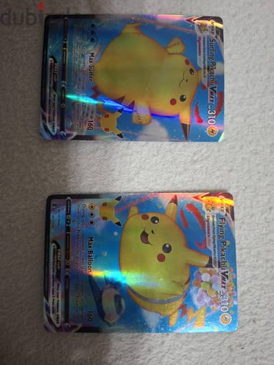 Surfing and flying pikachu VMAX pokemon cards in excellent condition