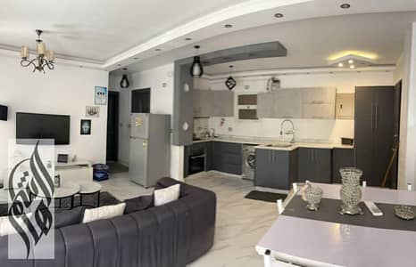 Fully furnished apartment for rent in Madinaty B6, 91 sqm + 50 sqm private garden, 2 bedrooms, living room, prime location near all services.
