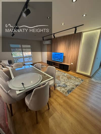 Apartment for sale in Madinaty B11, 116 square meters, 3 bedrooms including a master bedroom, 2 bathrooms, second floor, directly in front of services, distinctive sea view, fully special finishes, completely new furnishings, fully air-conditioned, from Talaat Mostafa, ready for immediate occupancy.