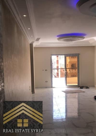 Al-Shorouk City for rent: second floor, front view, apartment with 3 large rooms, 2 bathrooms, kitchen, living room, and balcony, super lux. Second occupant, new rental law, empty, area 7, next to Al-Adham Mosque and the new mall, and on the largest park in Al-Shorouk, third building from the middle, 24-hour security in front of a large garden.