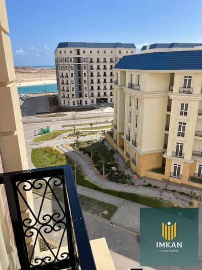 An apartment for sale in the Latin District of New Alamein, featuring a "super-lux" finish and a prime, direct view of the lagoon and the towers. It i