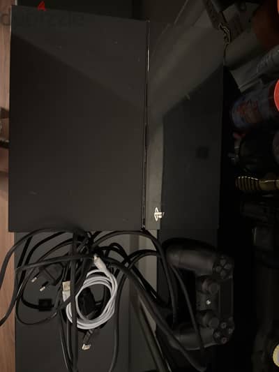 PlayStation 4 with controller and wires