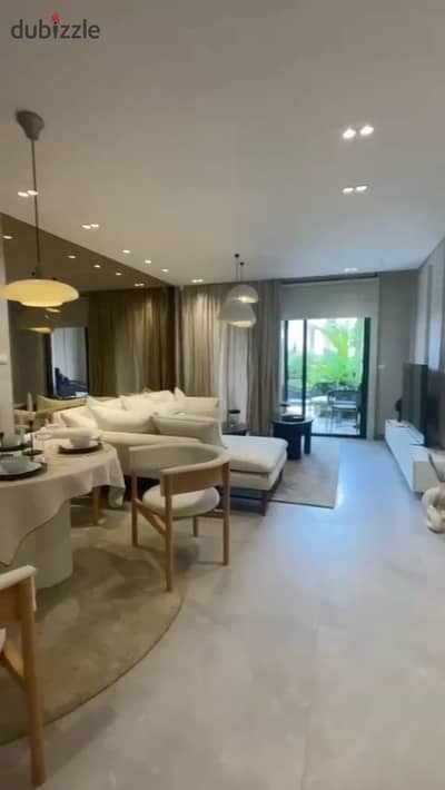 Finished ground floor apartment with garden for sale in Village West Compound, Sheikh Zayed