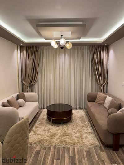 For rent furnished in my city, an apartment consisting of 3 rooms and 2 bathrooms, a kitchen, and a reception area, with 2 terraces, fully air-conditioned, super-luxury special finishing next to all services with a garden view.