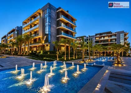 Apartment with Garden  for sale, in La Vista Patio Oro compound, featuring an open view overlooking the pools, prime location New Cairo