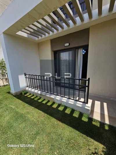 Fully furnished ground-floor apartment with a garden for rent in Fifth Square Compound; includes air conditioning and a kitchen.