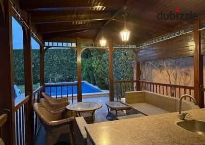 A stunning villa with a garden and a large swimming pool is available for sale in a luxurious compound within the Golden Square. It features high-end