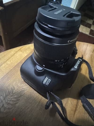 Camera EOS 2000 D with cover and memory card