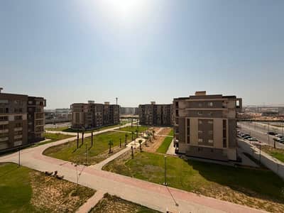 Apartment for rent in Janna 4, Sheikh Zayed. It features an open view of the landscape and a swimming pool, boasting a prime location and a wonderful