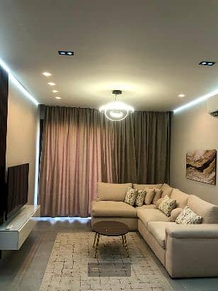For rent: a fully furnished apartment in Village West Compound - Sheikh Zayed - high-end finishing with modern furniture