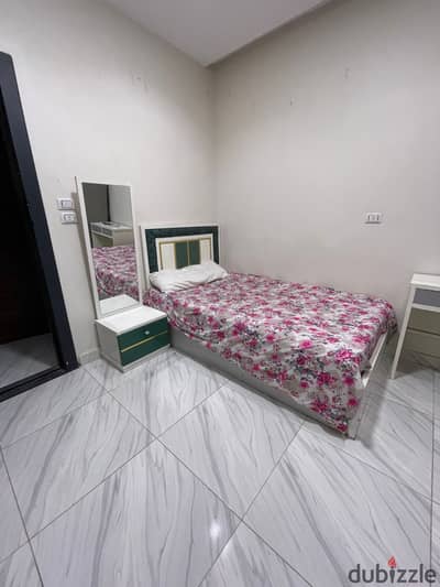 Studio is available for rent in 6 October City, first neighborhood, near 6, second floor, including water and electricity, and a guard. Clean furniture, close to all services, a minute away from Al-Hosary Mosque.