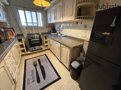 Apartment for rent in Beverly Hills Compound, Sheikh Zayed City – 150 sqm, featuring a view of a large square; includes kitchen and air conditioning.