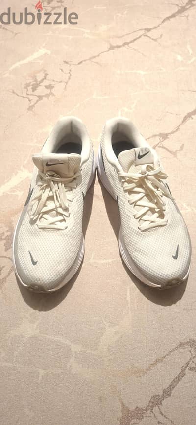Nike Revolution 8 running shoes in a beige