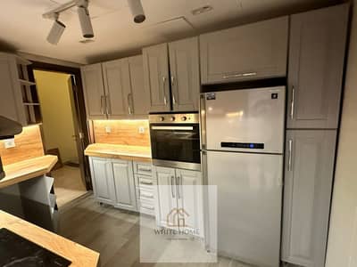 Apartment with kitchen, air conditioning, and ultra-modern appliances in Cairo Festival City compound, available for rent at a special price.