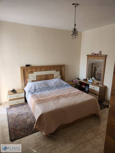 Furnished, fully air-conditioned apartment with a garden view for rent in Al Rehab, Phase 5, near main roads.