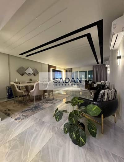 Apartment with a garden for sale with a 50% discount, directly opposite Cairo Airport, in Taj City Compound, New Cairo.
