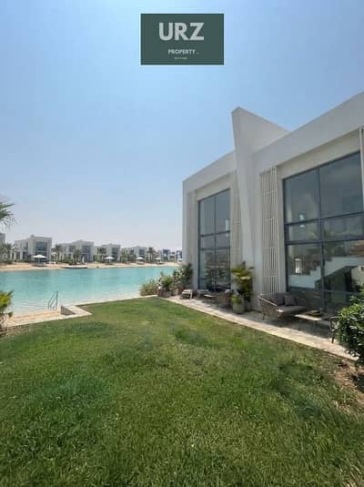 Ground-floor chalet with garden, first row lagoon view, ACs, installments, and 35% discount in Ras El Hekma near The Med, Azha & Cascades.