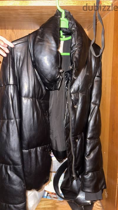 Women’s Black leather puffer jacket.