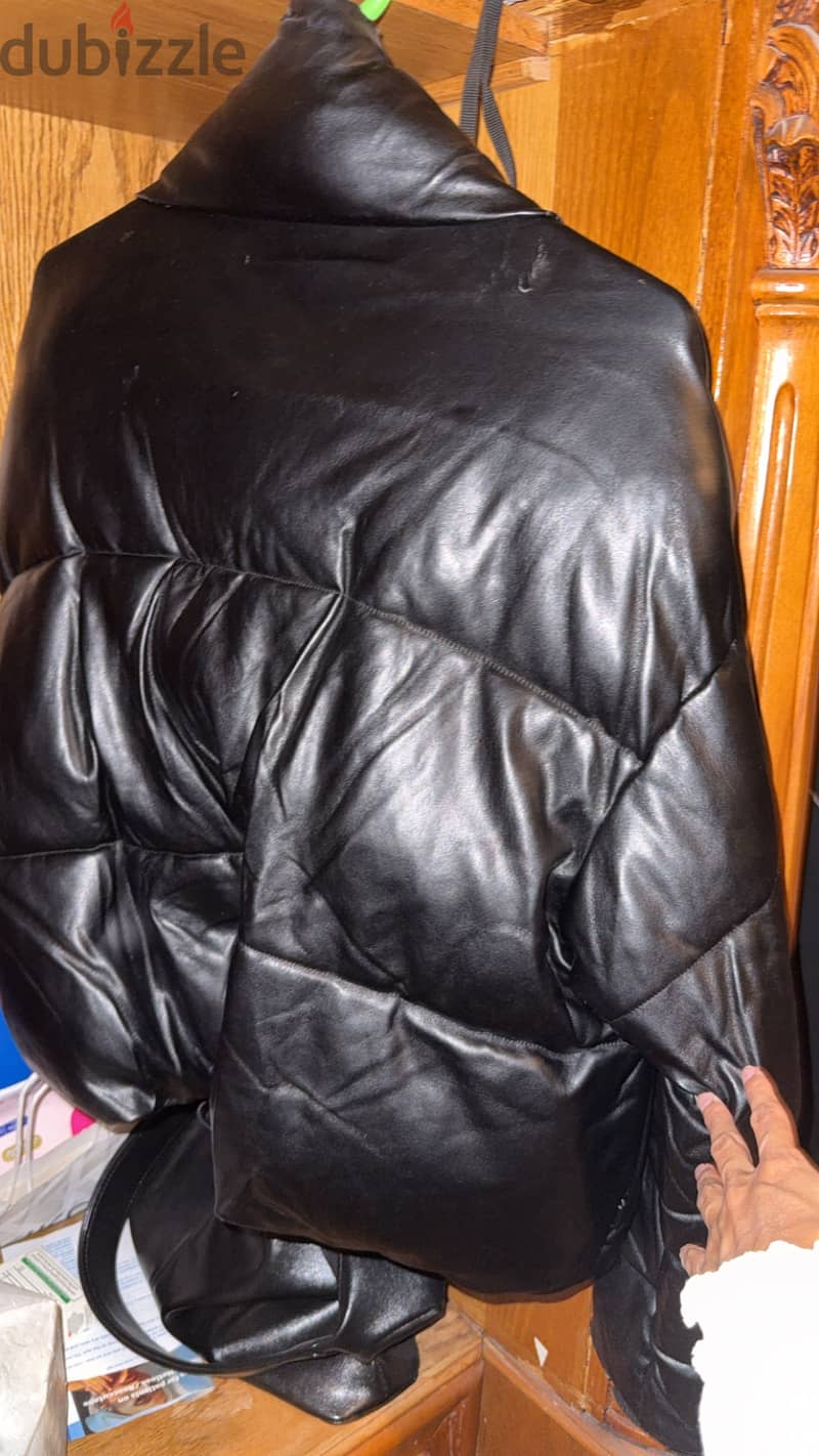 Women’s Black leather puffer jacket. 1