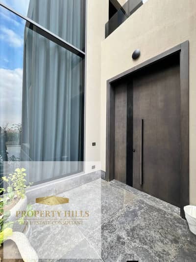 Villa with water way, spacious area, and a competitive price in a compound of villas only in front of Palm Hills in prime location with an open view