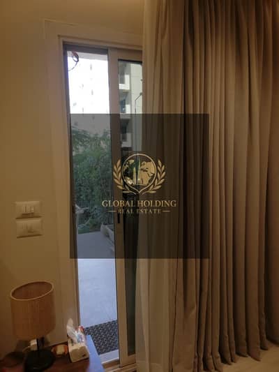 Fully finished ground-floor apartment with a garden in Taj City (Taj Sultan phase) – resale.