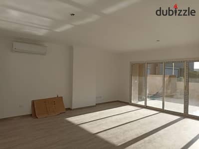 Ground-floor apartment with a large garden for rent in The Square compound; includes kitchen and air conditioning units.