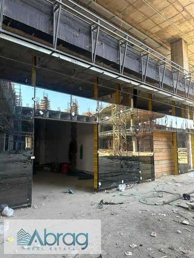 Ground-floor commercial unit for sale with a 7-year payment plan – Mehwar Plaza Mall, Central Axis, 6th of October City.