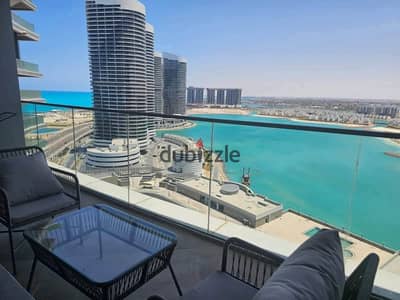Fully finished chalet for sale—featuring hotel-standard interiors—located in the towers of New Alamein City (North Coast), boasting a direct panoramic