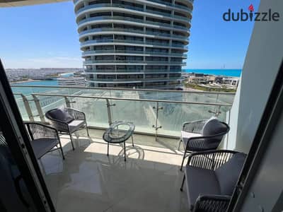 Fully finished chalet for sale—featuring hotel-standard interiors—located in the towers of New Alamein City (North Coast), boasting a direct panoramic