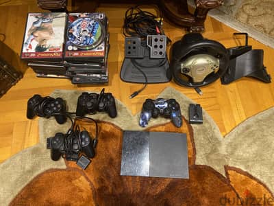 PS2 slim + 2 controllers + steering wheel + games