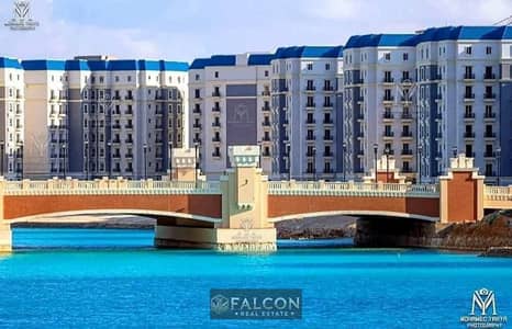 With 30% Discount Recieve immediately a Ready To move & Fully Finished 2BR facing North in Latin District with Lagoon & New Alamein Towers View