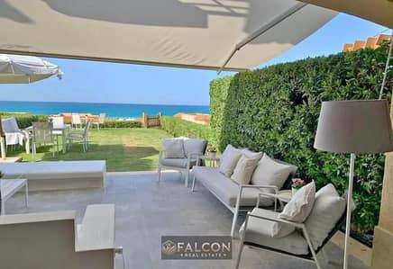 Own a chalet with a private garden—featuring high-end finishing—first row from  the sea at Telal North Coast.