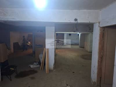 Warehouse for rent, 500 sqm, located directly behind Al Ahly Club Street on a two-way street—6th District, Nasr City.
