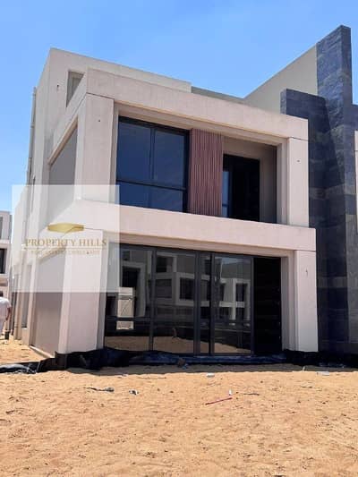 Corner Villa for sale in the Patio Town with a view of swimming pools, along with a large garden next to AUC in the Fifth Settlement.