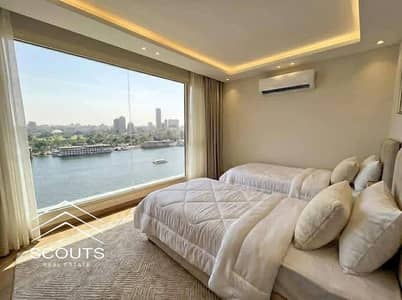 Furnished apartment for sale with a high investment return at Reve du Nil Towers, managed by InterContinental. Direct Nile & Gold Island view