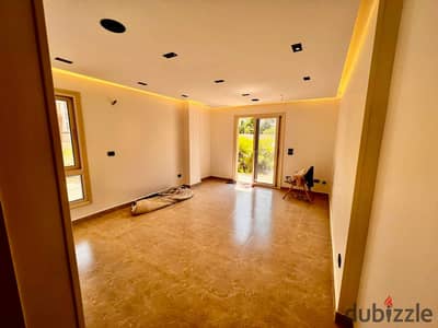 Ground-floor studio with a garden for rent in Taj City compound; first-time occupancy, featuring a distinctive view of the landscaping.