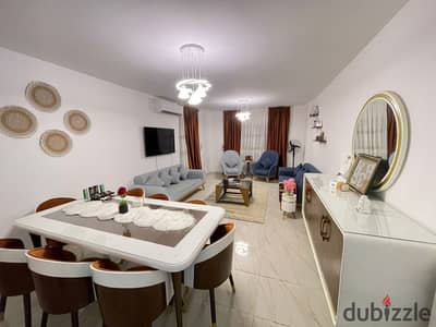 140 sqm furnished apartment for rent in Madinaty; custom finishes, modern furniture, and a garden view.