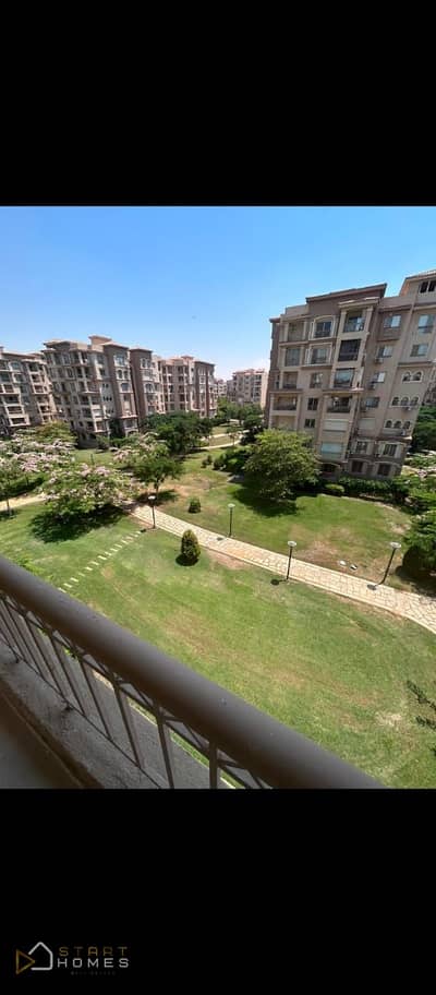 Unfurnished 175-square-meter apartment for rent in Madinaty (B2), near the club and amenities, featuring an open view of a wide garden.