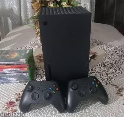 xbox seriesx with two controllers and a bundle of 9 physical games