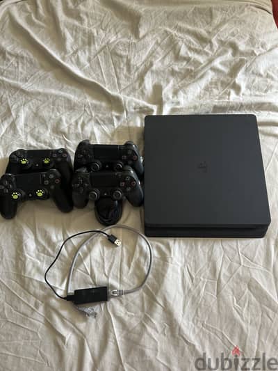 playstation 4 slim 1TB with 3 games and 4 controllers