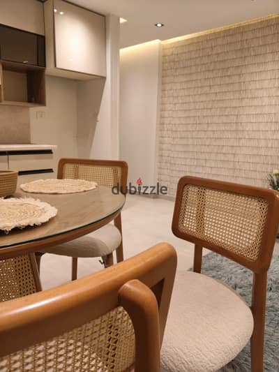 For sale: A fully finished and furnished apartment (including air conditioning) available for immediate handover. It features a direct view of the Nil
