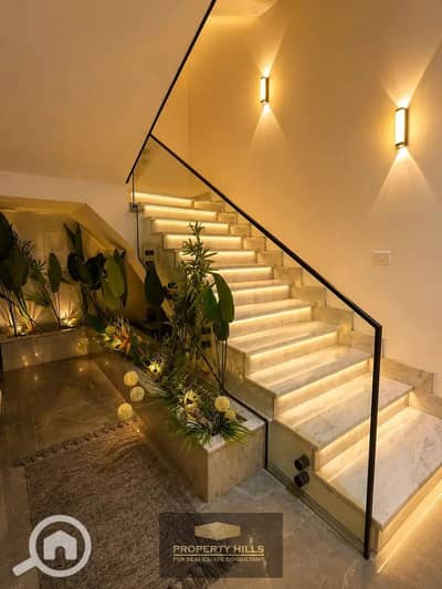 Receive a twin villa in a garden with High-End finishing with a lagoon view in the heart of Sheikh Zayed next to Al Rabwah