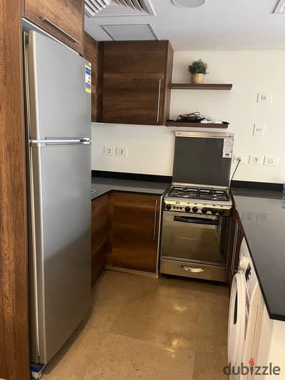 Studio for rent in Jasper Hills, New Giza – 6th of October City. Includes kitchen, air conditioning, and appliances.