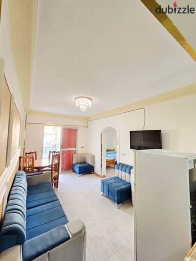 Luxury apartment with furniture and appliances at Palm Beach, Al-Ajami, and there is a swimming pool for the property